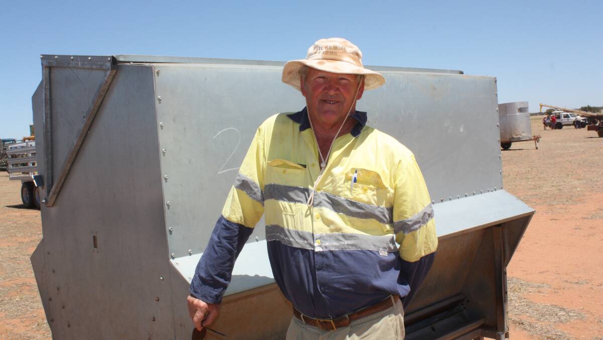  Salmon Gums farmer Terry Guest had more on his mind than last Friday's clearing sale after being alerted to a fire that closed roads to his farm. "I guess it'll be the long way round for me going home," he said. He was pictured in front of one of four Universal sheep feeders which made between $1800 and $2100 each.