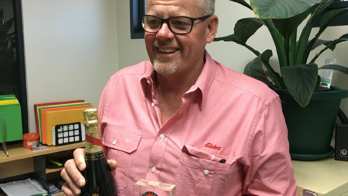 Don Fry, Elders Southern Districts, Bunbury, gets ready to celebrate being named one of seven Elite salespeople from WA for 2019 with a bottle of bubbly.