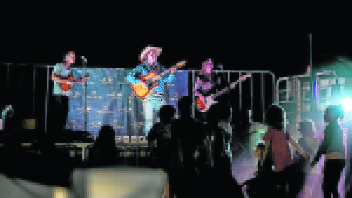  Tom (centre) on stage with Chris Matthews and Kate Hindle will perform at the New Years Eve Campdraft at Boar Swamp Road, Blythewood.