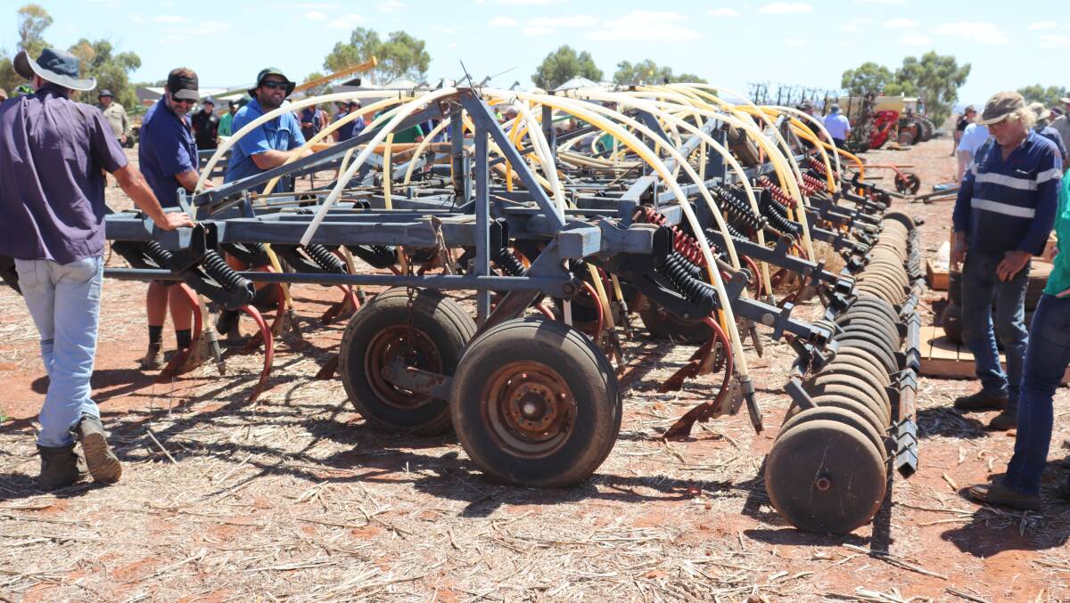 This 1996 Flexi-Coil 820 seeder bar sold for $8500. Pictured here are a number of potential buyers looking over the bar as the bidding got underway.