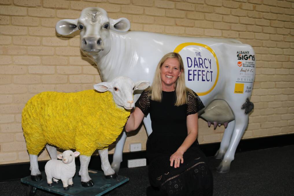 Narrikup farmer and mother of three Kate Mitchell with her charity cow (and the Ray White office sheep) used to promote The Darcy Effect for which Ray White Rural Albany Kojonup is one of the sponsors. Named after her son Darcy who was diagnosed with severe epilepsy and suffers life threatening seizures, Ms Mitchell, has made it her mission to help other rural people who find themselves in hospital emergency wards with little more than the clothes they are wearing at the time. She posts out empty bags for donors to fill with essential items like toothpaste and deodorant, but also books and toys for children which they then drop off to their local hospital to be handed out to others like her and is also championing the importance for people and especially rural people, children included, to learn basic first aid skills.