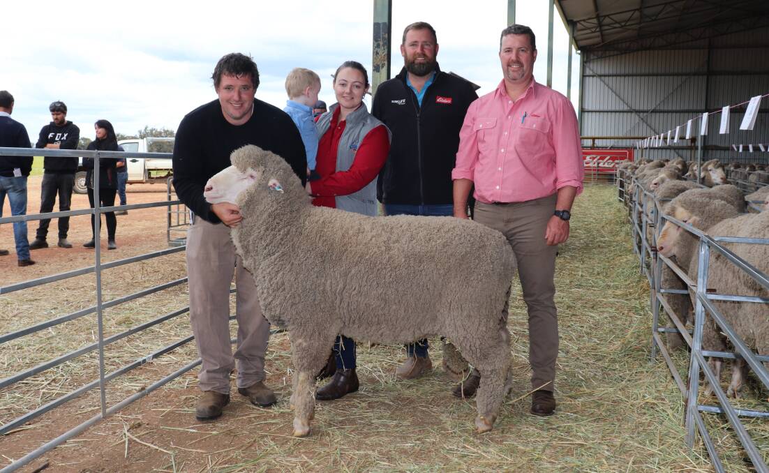 Seymour Park stud principal Clinton Blight (left), son William, 2, and wife Sarah Blight, buyer Pete Cowan, Crichton Vale stud, Narembeen and Nathan King, Elders stuck stock, with the $18,500 second top-priced ram at the Seymour Park sale.