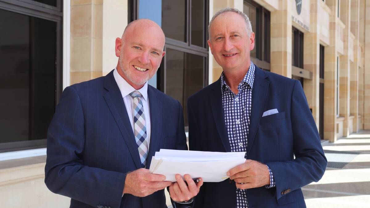 Agricultural Region MP Colin de Grussa (left) and CEPA WA president Ian Wilson with a petition calling for an inquiry into the state of the WA egg industry. 