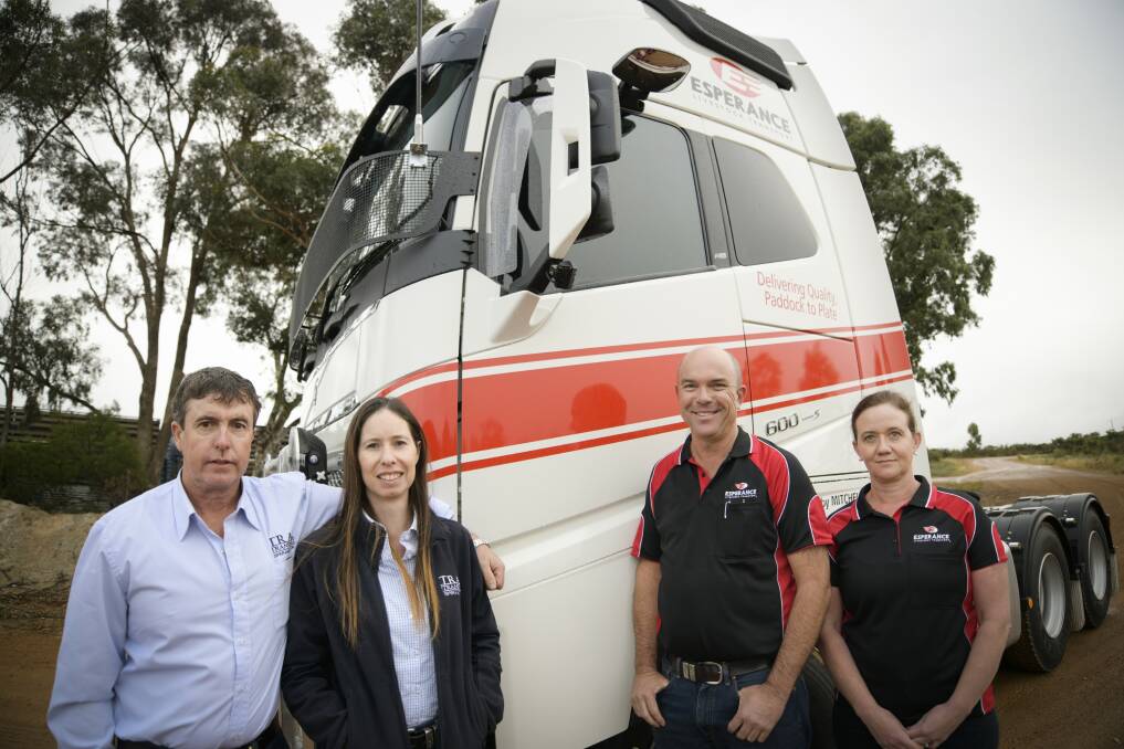 Peter (left) and Billy Bartlett with John and Lisa Mitchell celebrate the transition of TRAC Transport's livestock division to Mitchell's Livestock Transport.