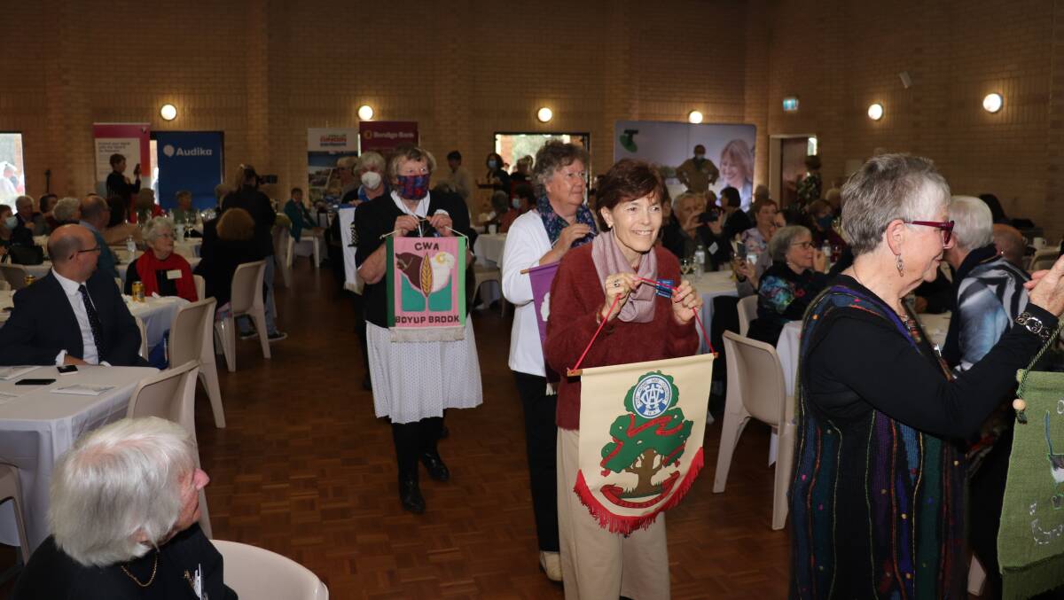 The Country Womens Association members showing off their well crafted branch banners at the CWA conference, held in Gingin in July.