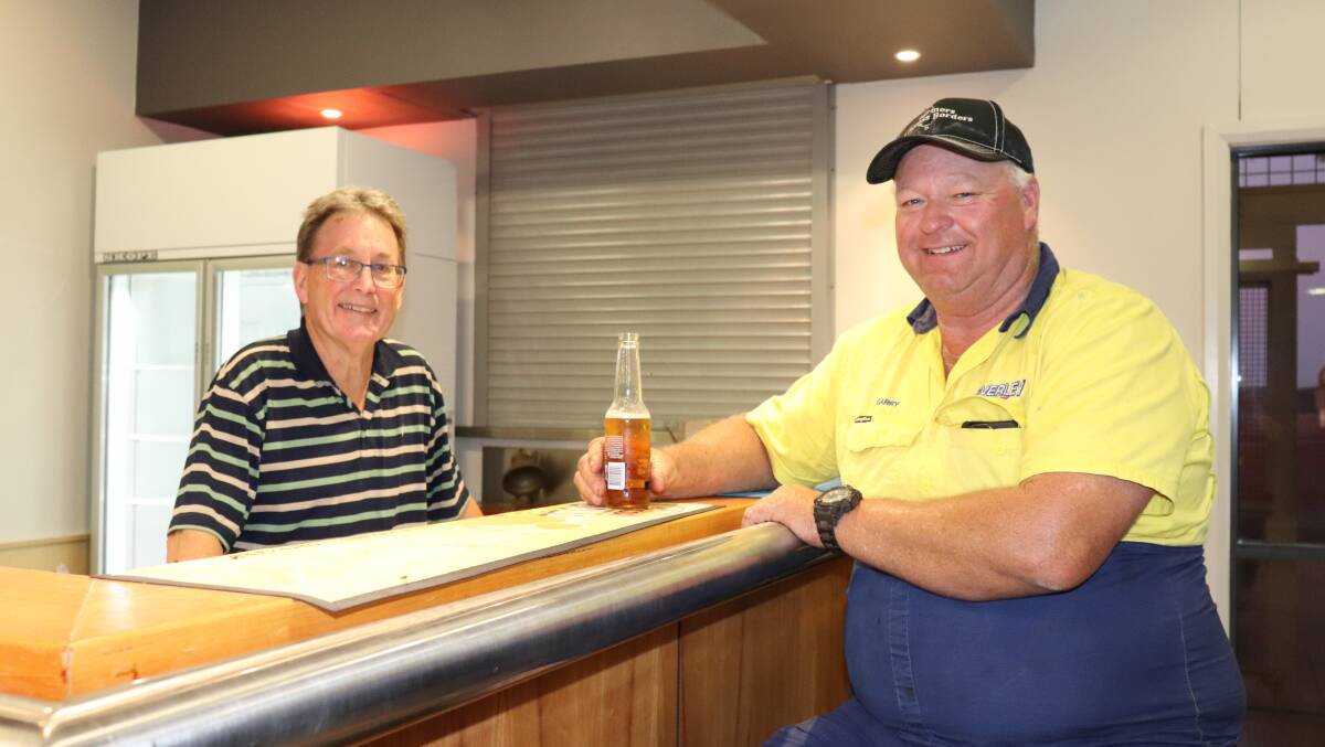 Behind the bar at Leonora were John Vincent (left), visiting from Albany, and hay run driver Garry Miller, Beverley.