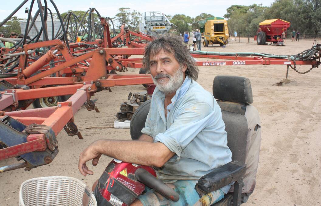 Goodlands farmer Rob Hester looks over a seeding rig which was offered as a whole Morris 9000 bar and Simplicity 13000 air seeder. It sold for $44,000.