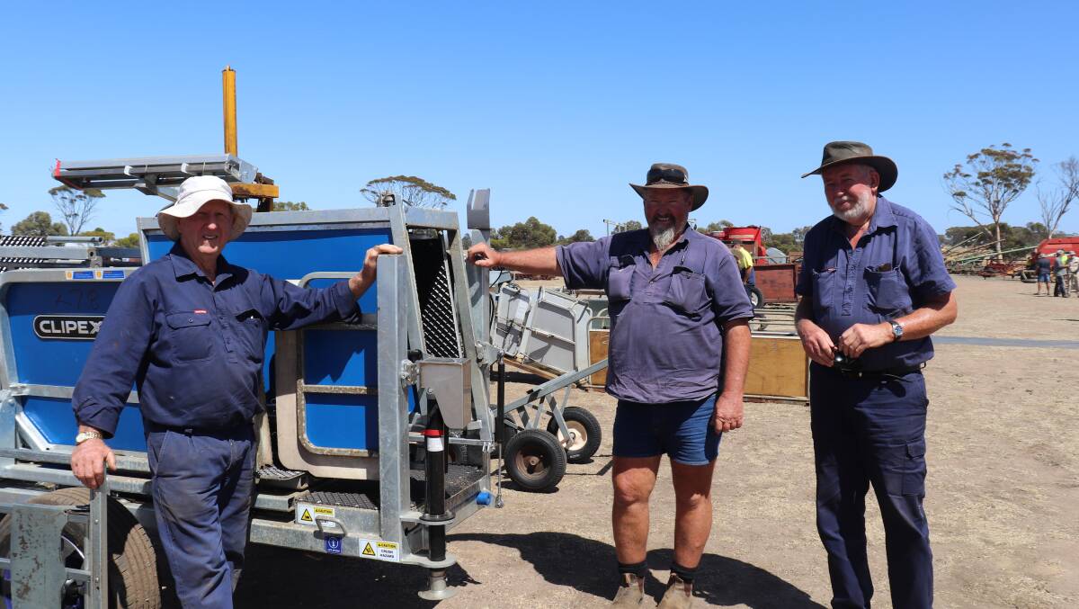 Norm Wiese (left), Collie, John Lakin, Napier and Dave Hill, Albany, check out the near-new Clipex sheep handler that sold privately for $25,000.