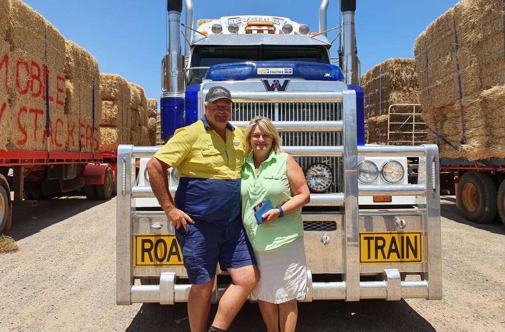 Farmers and owners of Beverley Transport Service Garry and Sarah Miller in front of their truck while stopped south of Kalgoorlie.