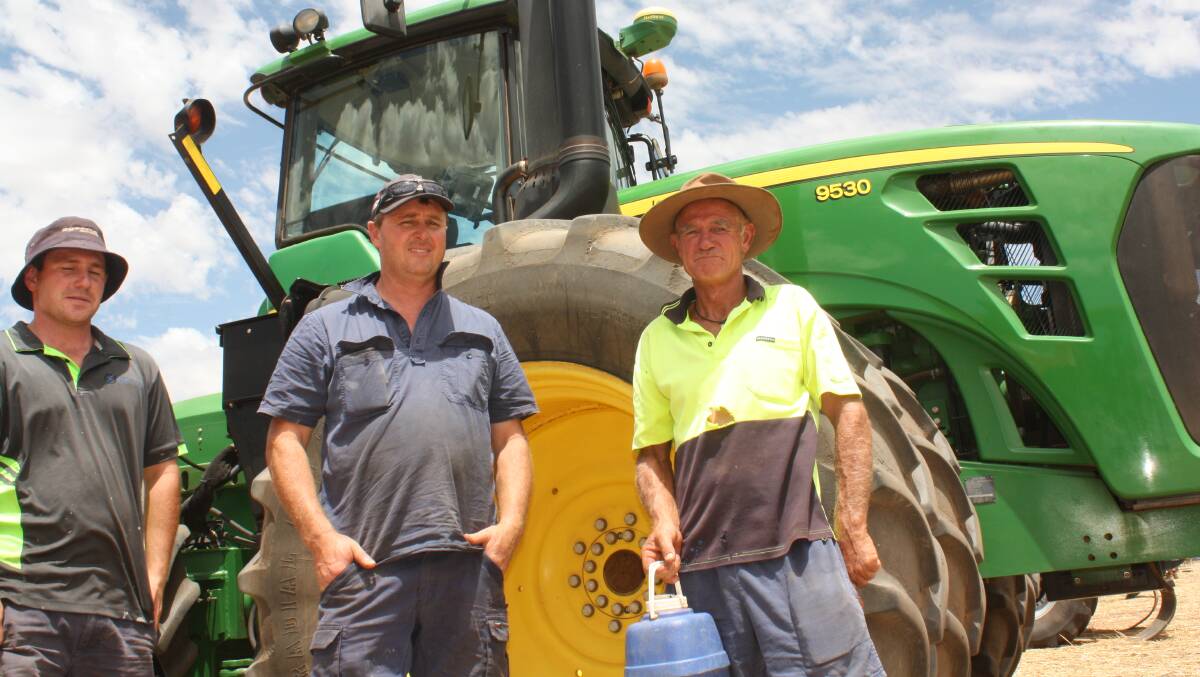 Miling farmers Brady Pearson (left), Paul White and Wade Pearson looking over this John Deere 9530 4WD tractor which attracted spirited bidding before reaching a winning bid of $140,000.