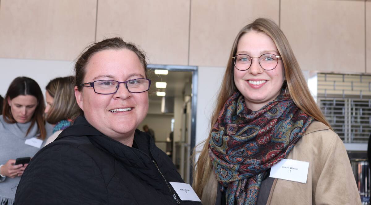 p Farmer Kaitlin Bryant (left), Latham with German foreign exchange worker Sarah Winter.