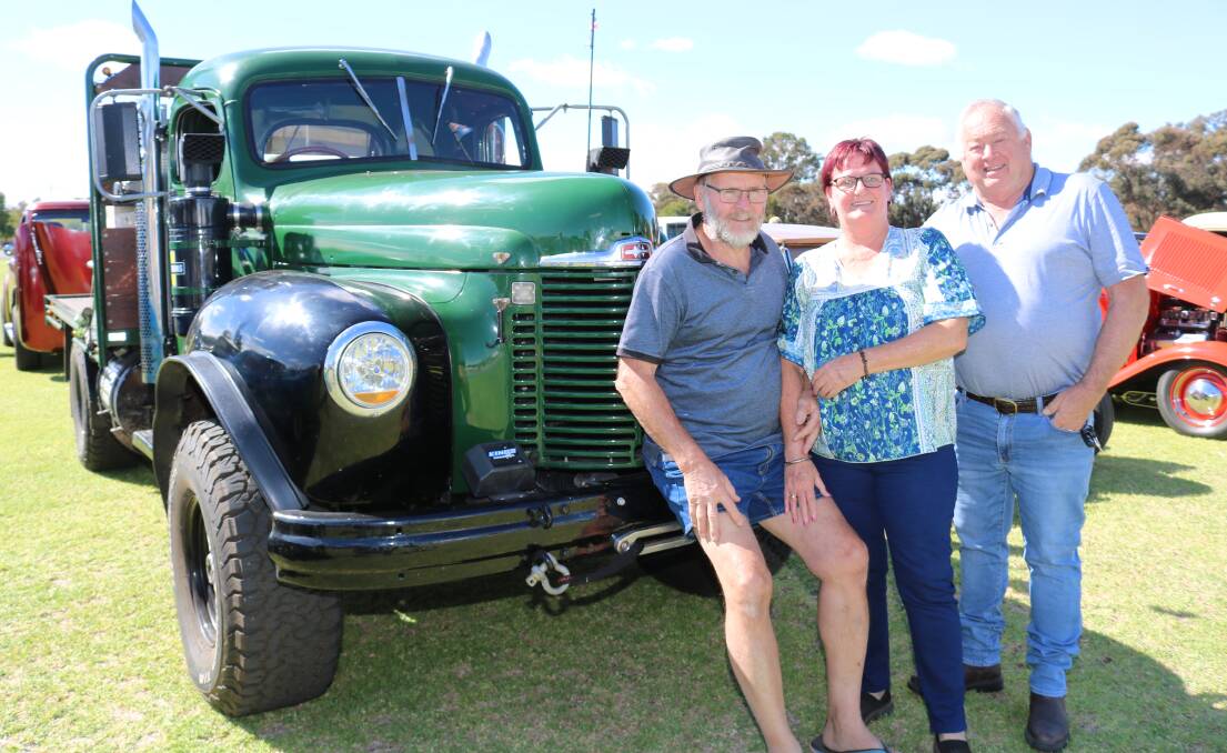 Former Williams farmer Paul Phillis (left)and his partner Peta Brown, with friend Geoff Pumphrey, Canningvale and Mr Phillis's International 1943 model, 8 tonne truck in the vintage display.