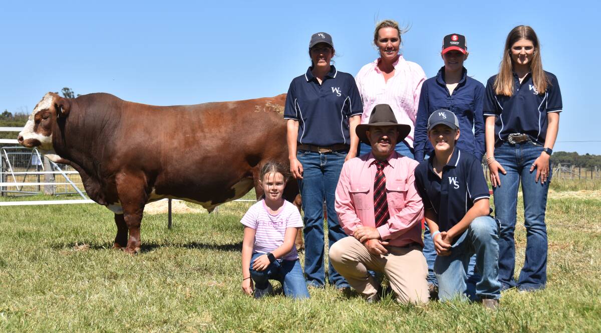 Woonallee stud's Lizzy Baker, Kelly and Mia Boers, Olivia Baker, kneeling Lucy Boers, 8, Elders auctioneer Ben Finch and Woonallee's Harry Baker with the $40,000 sale topper, Woonallee Trojan. Picture by Catherine Miller