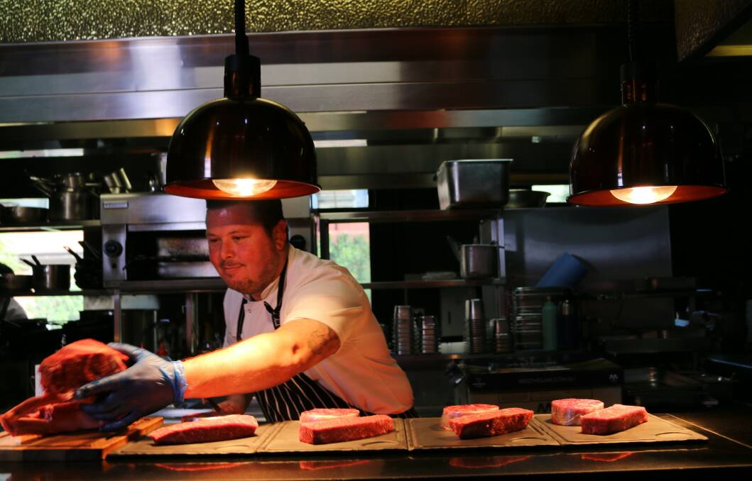 FULL OF FLAVOUR: Brisbane chef Trent Robson preparing Westholme Wagyu for cooking.