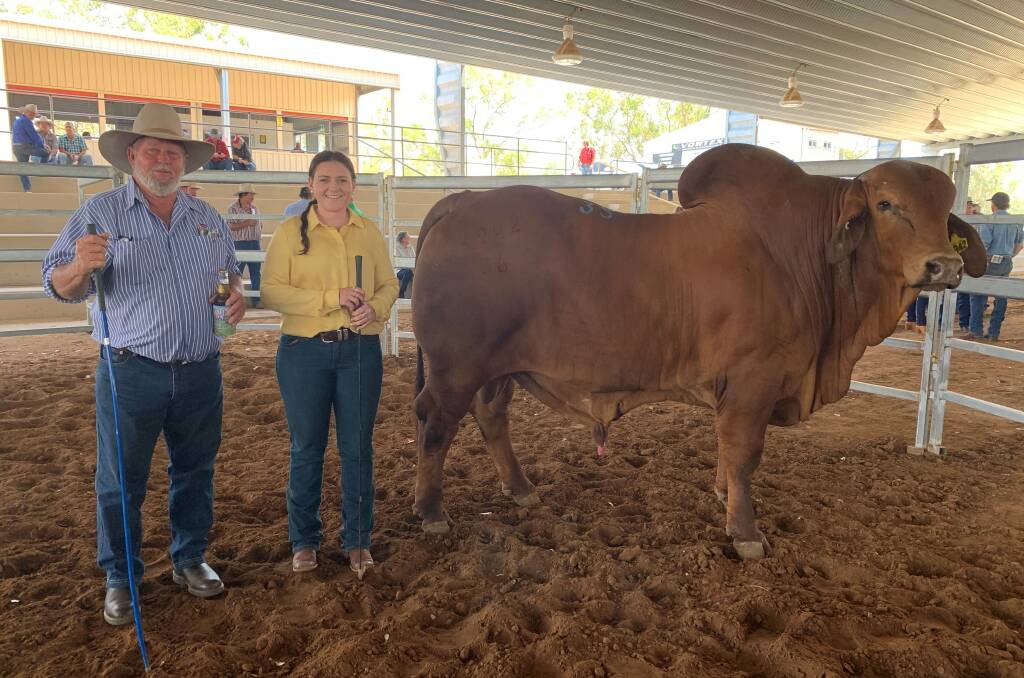 Ken Rutherford pictured with Lucie-Anne Kirk and top priced bull Hazelton Milburn 4942, who sold for $20,000.