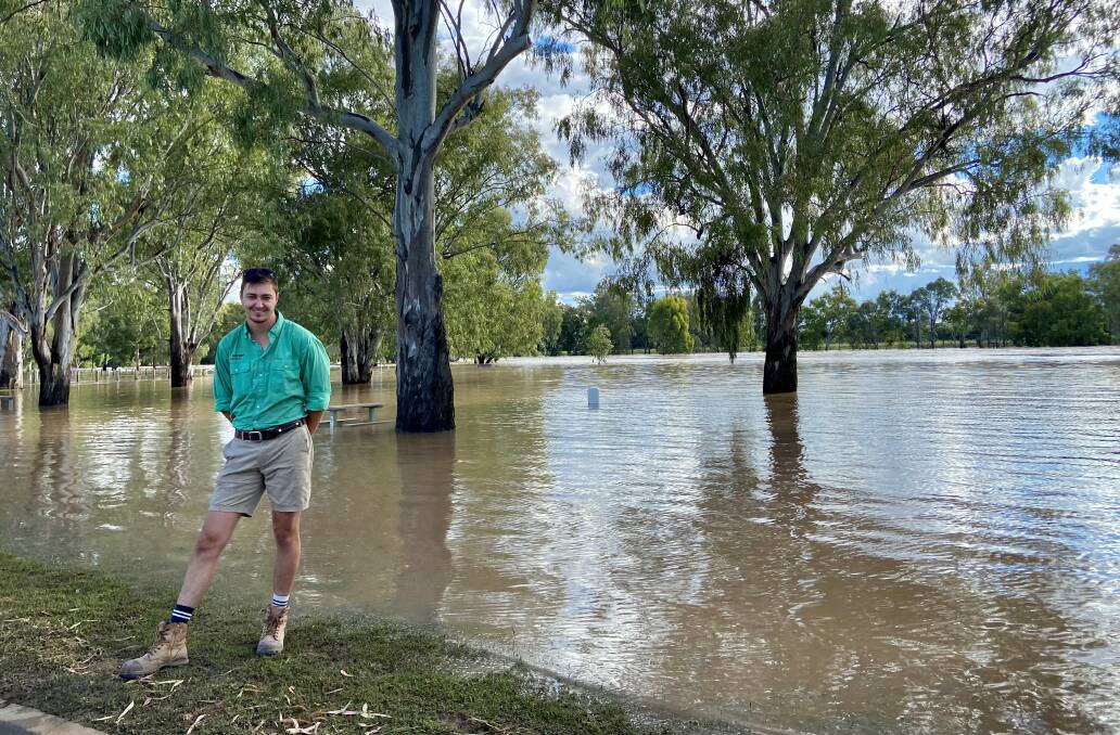 Nutrien agronomist Connor Parkes near a flooded Namoi River in Narrabri.