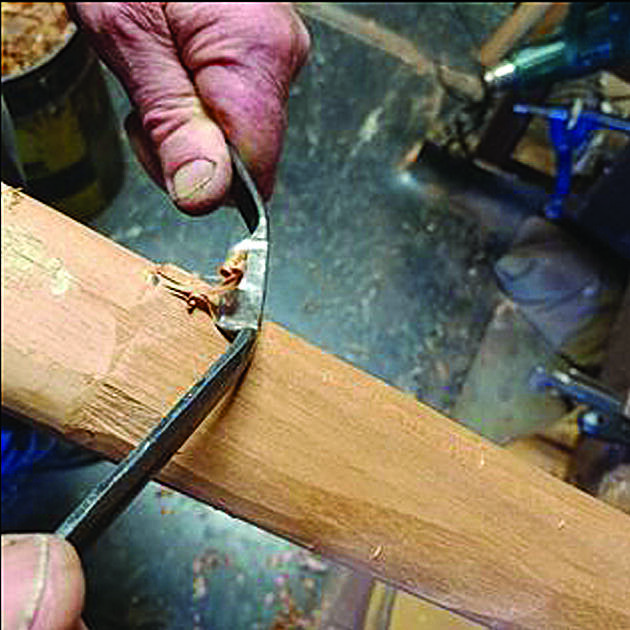 Mr Wise carves the neck of a guitar. The contemplative process involves using a collection of hand tools including a small drawknife and spokeshave, and a French rasp, Japanese wood file and sometimes a kitchen microplane to even out and shape the curves.