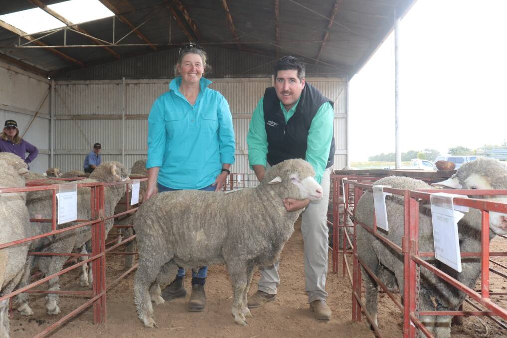 Monte Verde Merino and Poll Merino stud co-principal Fiona Hall, with the $2600 top-price ram which sold to M Cooke & Sons, Grass Valley, held by Nutrien Livestock auctioneer and Mt Barker agent Jarrad Hubbard.