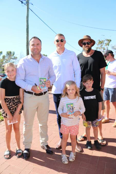 Watched by his daughter Stella (left), 11, former Fremantle Docker Paul Hasleby, Carlton co-captain Patrick Cripps and West Coast Eagles goalkicking machine Josh Kennedy signed Northampton Rams AFL Legends memorabilia cards for Northampton fans Sophie and Patrick Davis.