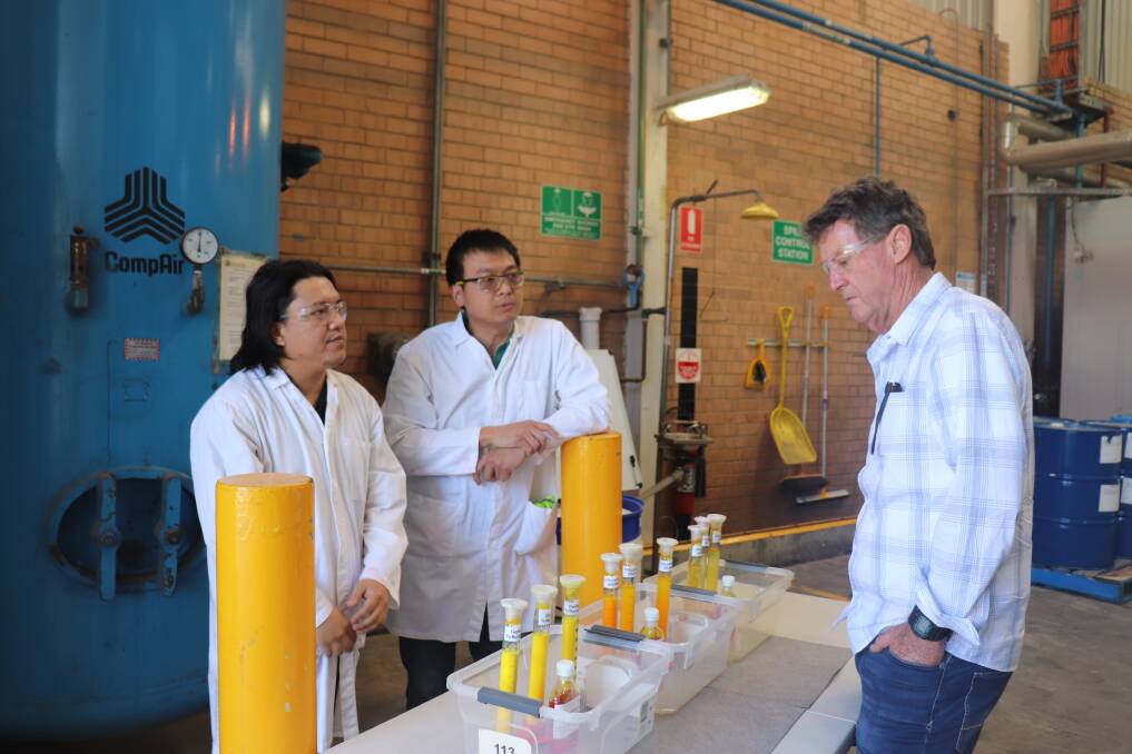 Nutrien Ag Solutions chemists Geronimo Marasigan (left) and Benjamin Lopez, with Coorow grower Rod Birch at the company's chemical and fertiliser production facility.