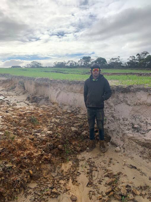 South Stirlings farmer Mal Thomson's biggest concern is washouts this paddock was seeded to barley six weeks ago, now the partial river created comes up to about stepson Rhys Robinson's hips.