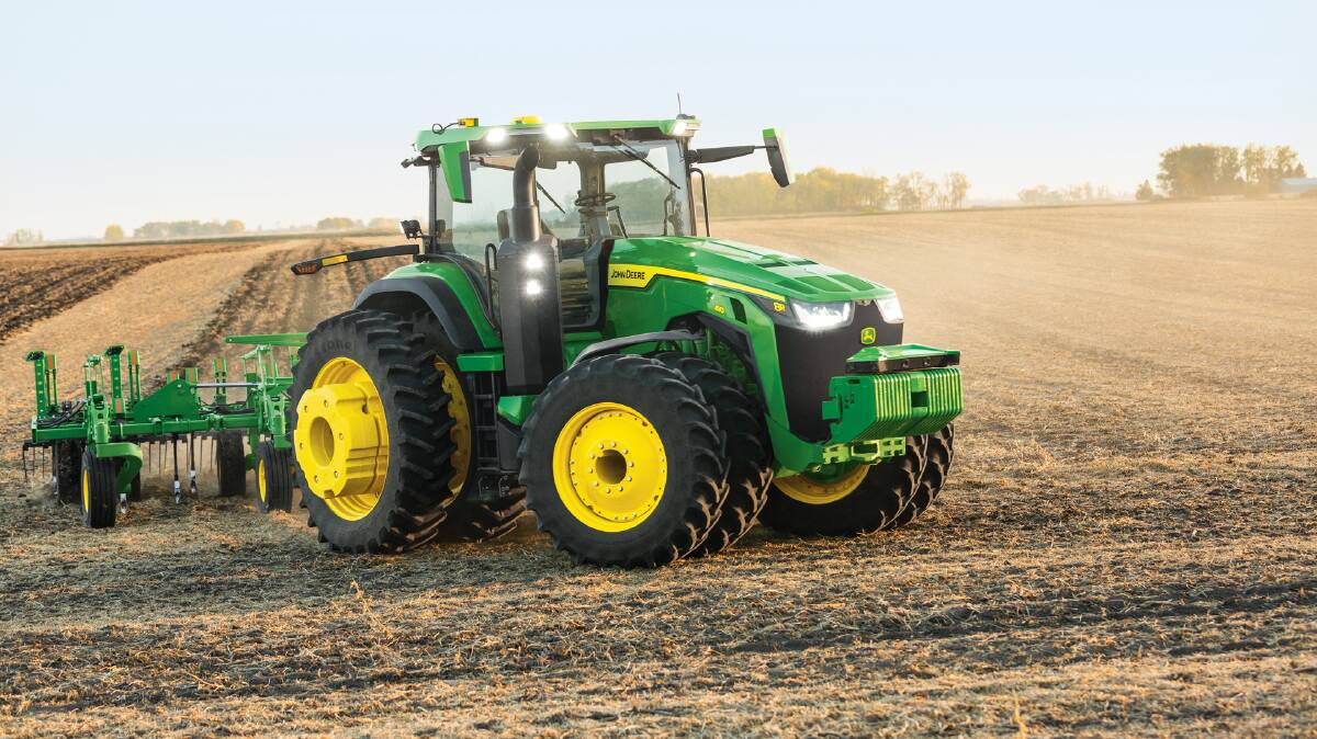 John Deere's production-ready autonomous 8R 410 tractor pulling a chisel plough making a turn at the end of a pass without anyone in the cab during trials.