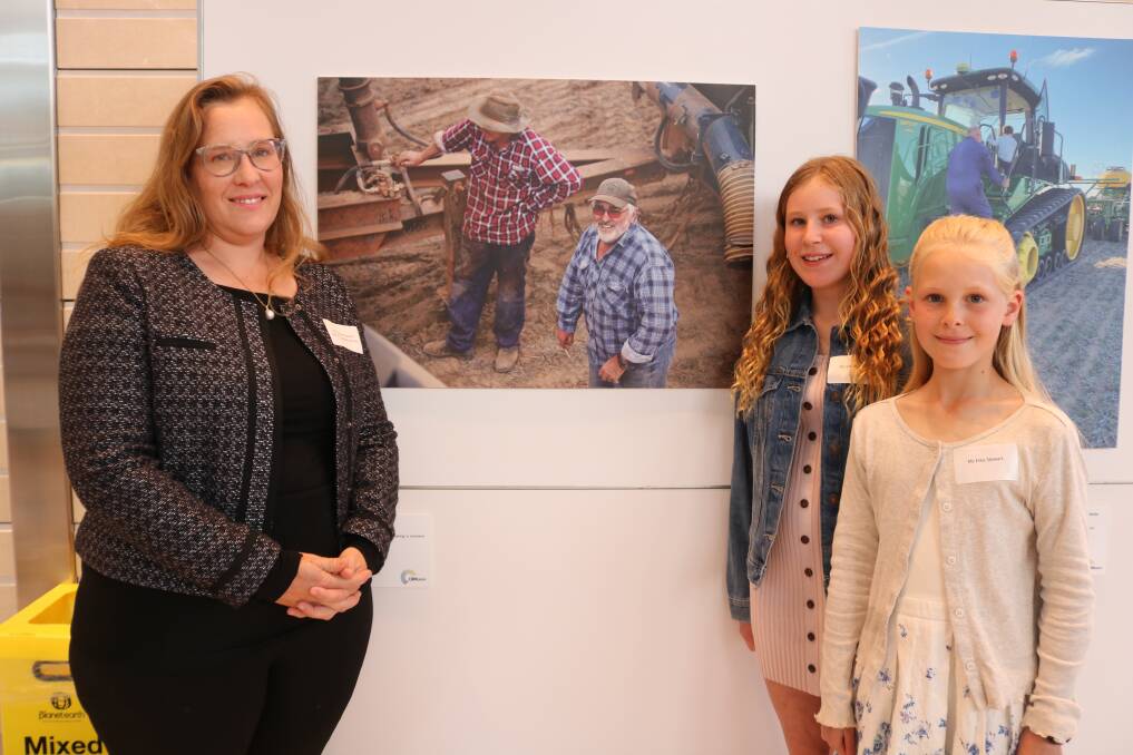 Amanda Stewart (left), Buniche, in front of her award-winning photograph with her daughters Saskia, 12, and Elika, 10.