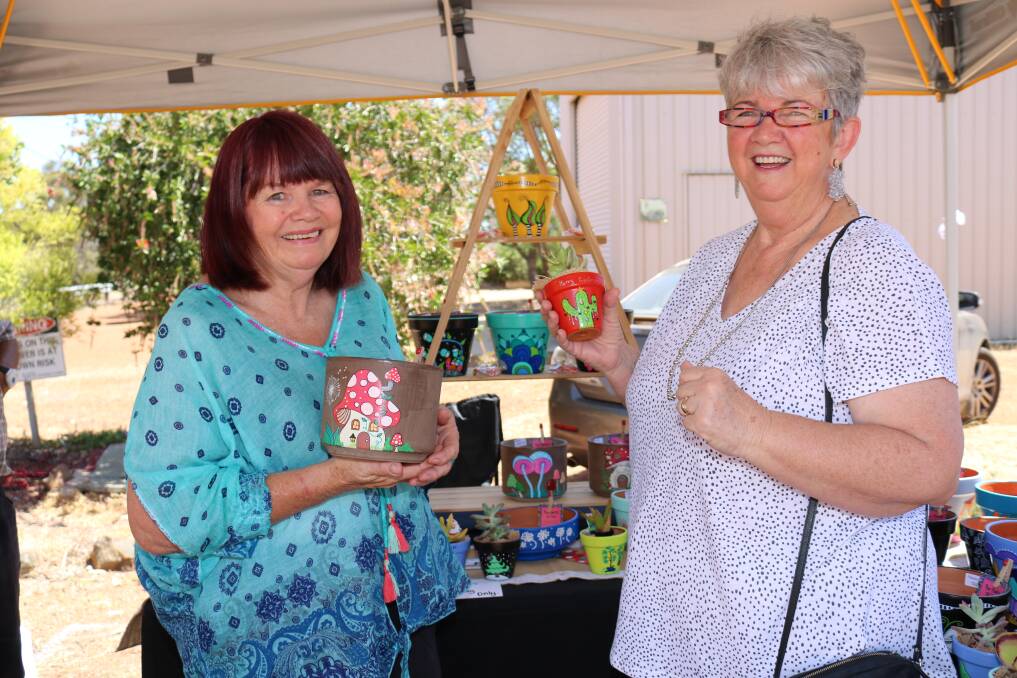  Trish May, The Poetry of Poets, showed some of her brightly painted plant pots and bowls to Heather Jones, Calingiri.