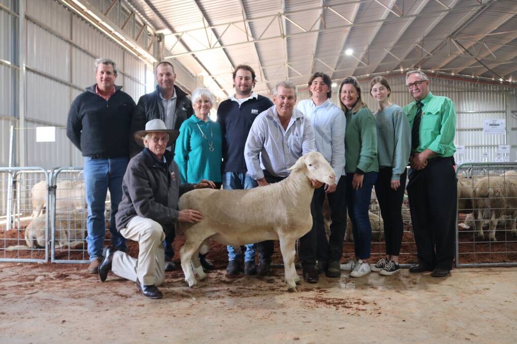 Kneeling with the record breaking $51,500 UltraWhite ram is Hillcroft Farms co-principal Dawson Bradford, which was purchased with the assistance of Elders Narrogin livestock agent Paul Keppel, (left), and bought by Kingslane UltraWhite stud manager Geoff Hillman, Benger. With them is the Bradford family, Greta, Jack, Dawson, Michael, Lisa and Chelsea, and Nutrien regional key account manager and auctioneer Steve Wright.
