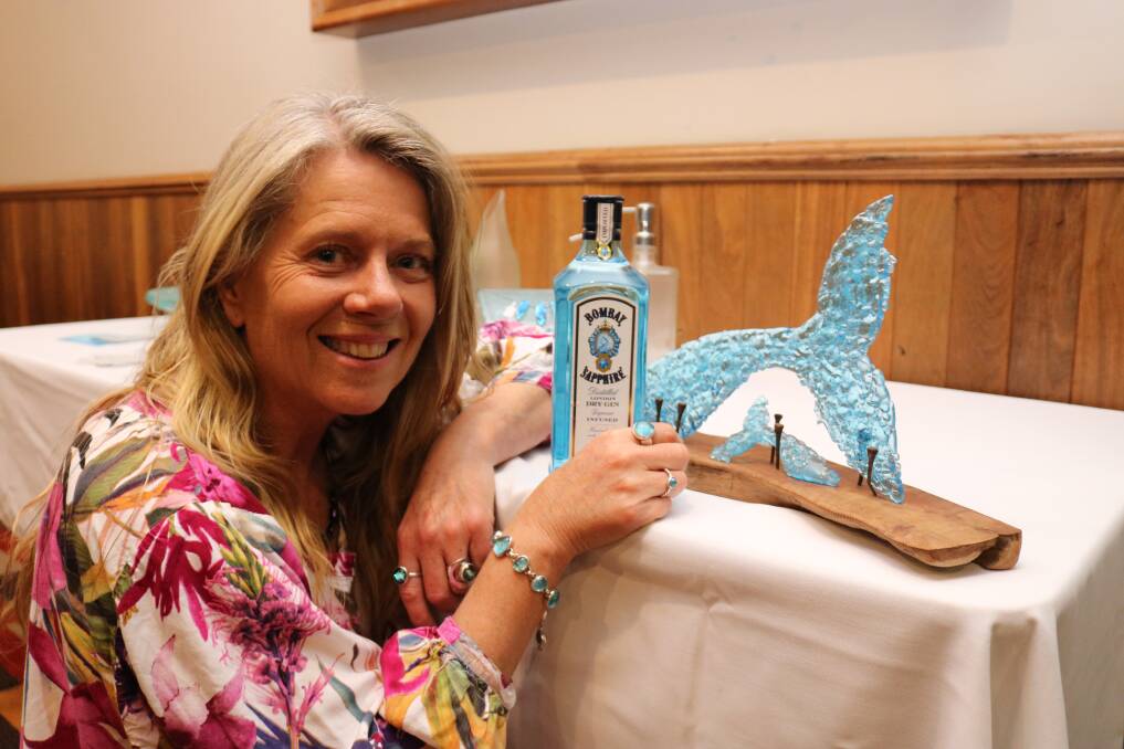 Esperance artist and event co-host Cindy Poole, with one of her artworks created from glass recycled from a gin bottle such as the one pictured.
