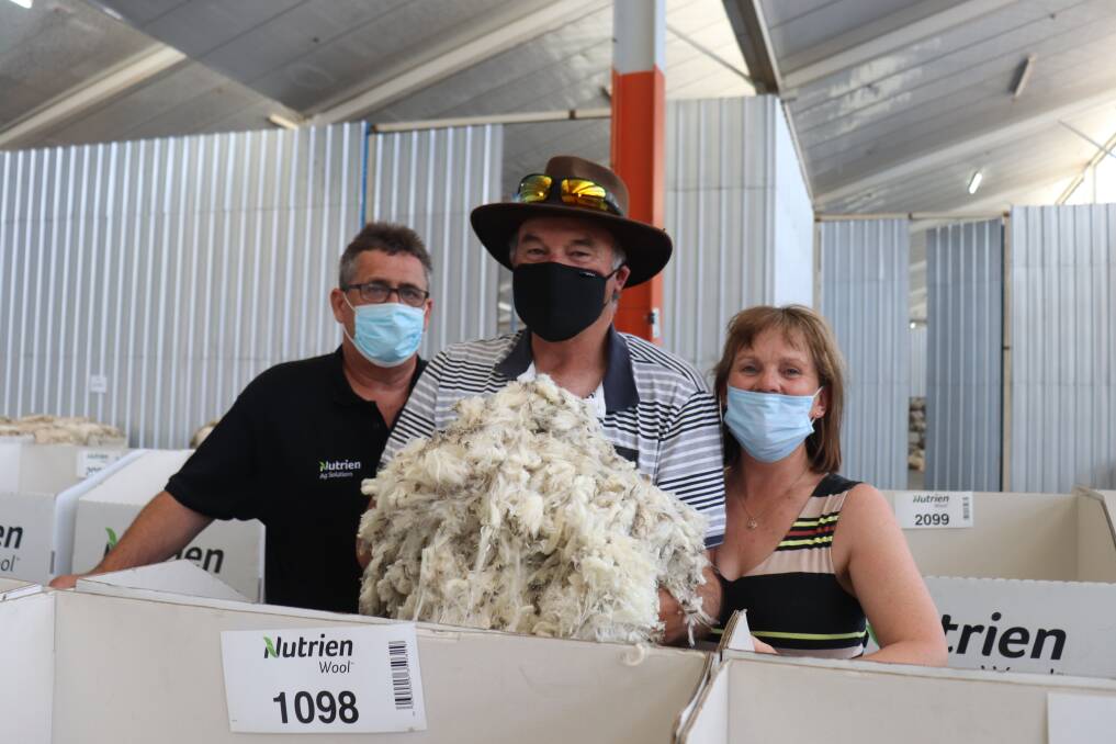 Nutrien Ag Solutions auctioneer Mark Goodall (left), with an ecstatic Chris and Pauline Norton, CA & PE Norton, Chorkerup, after their wool made top prices at the Western Wool Centre last week.