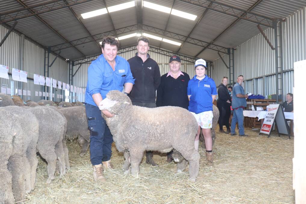 Warralea Poll Merino studs co-principal Jarrod King (left), holding the $6000 top-priced ram bought by Nathan Willmott, AM & TL Willmott, Tambellup, with Elders Albany agent Nigel Hawke and Fraser King, Warralea.