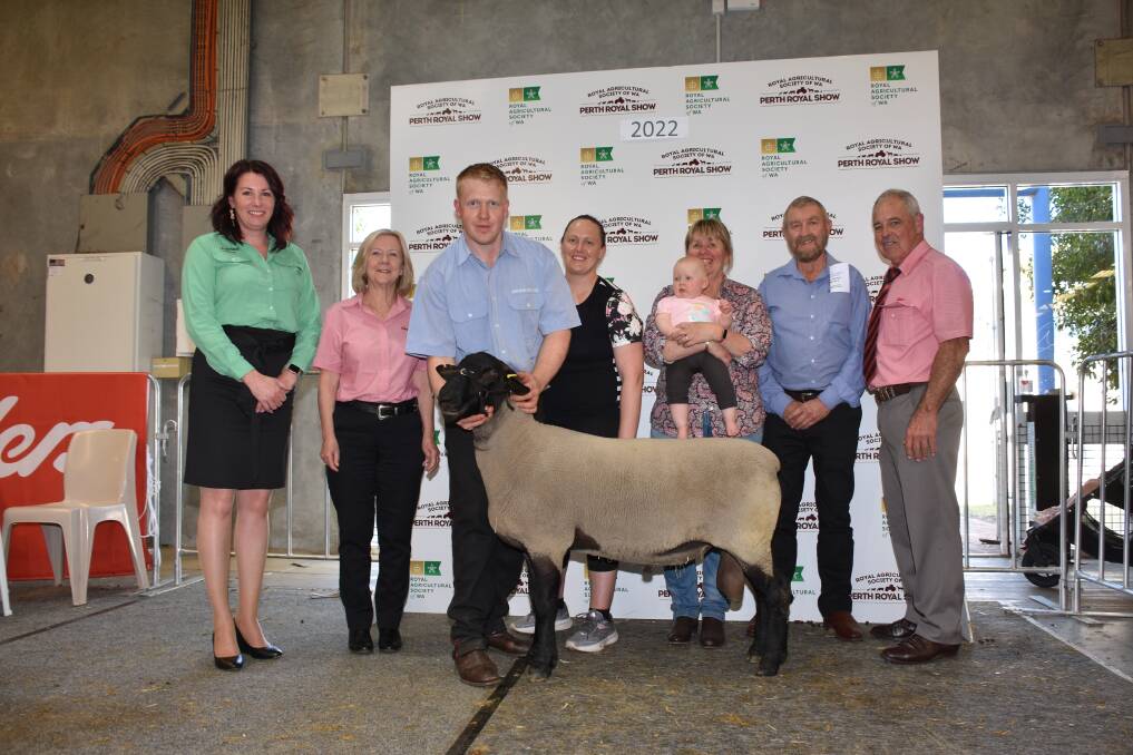 The $4200 top-priced Suffolk ram was sold by the Annaghdowns stud, McAlinden, to the Creagh family, Natawandi stud, Nillup. With the ram were Denise Taylor (left), Nutrien Livestock administration and Janet ODonnell, Elders livestock administration, Annaghdowns stud connections Thomas ONeill, Steph Laughton and Vicki ONeill holding granddaughter Lexi ONeill, Donald Cochrane, Perth, who represented the buyers and Elders auctioneer Preston Clarke.