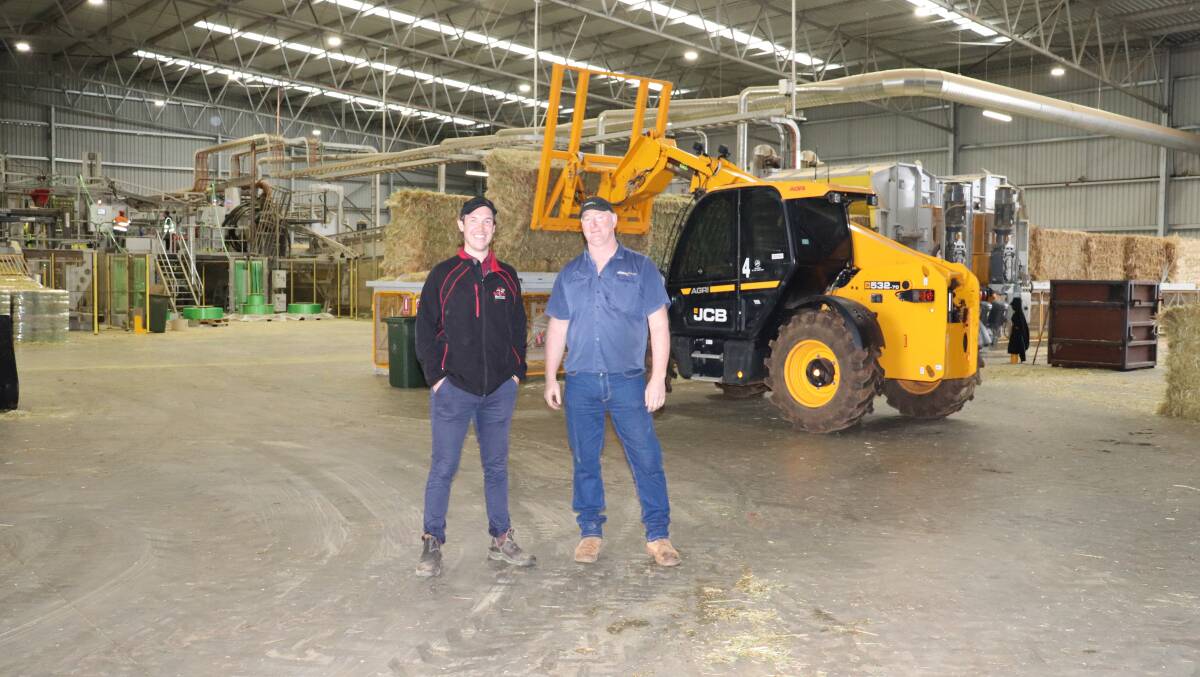 Boekeman Machinery sales consultant Ben Boekeman (left), with Aldahra production manager Tony Thompson inside the 104-metre long warehouse which houses the new industrial hay press. The new JCB 532-70 Agro Farm Special Telehandler is in the background where it is used to load oaten hay and straw onto the hay press.