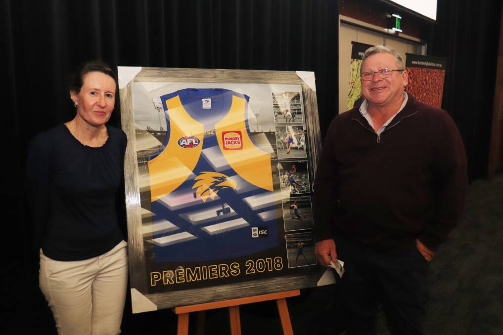 Nutrien Ag Solutions personal assistant to regional director Sue Morris (left) and Trayning farmer Mick McCormack, who won this 2018 West Coast Eagles premiership memorabilia.