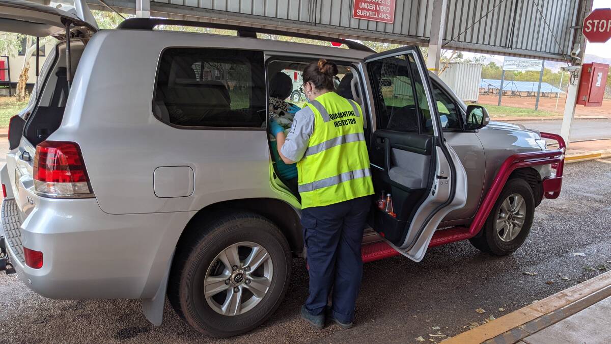 A DPIRD quarantine inspector examines a vehicle at the Kununurra checkpoint to help keep WA free from biosecurity pest and disease threats.
