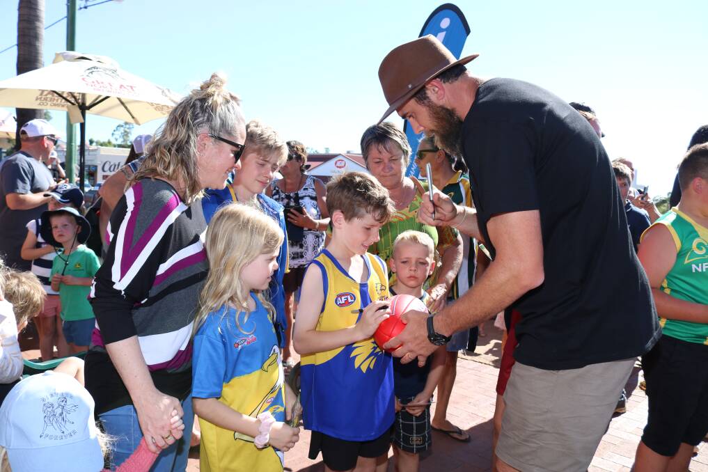 West Coast Eagle Josh Kennedy was kept busy signing for this group of mini Eagles fans.