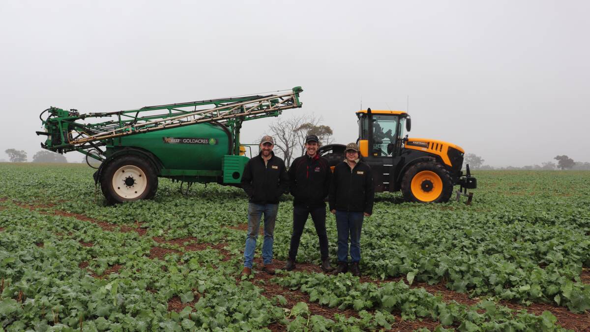 Farm employee James Howl (left), Coventry, United Kingdom, with Boekeman Machinery sales consultant Ben Boekeman and Bindoon mixed farmer Kristan Kelly in front of the new JCB 8330 Fastrac with a Goldacres sprayer. Mr Kelly said they would be spraying the paddock as soon as the rain stopped and hoped his Roundup Ready Canola crop would do well in the non-wetting soils.