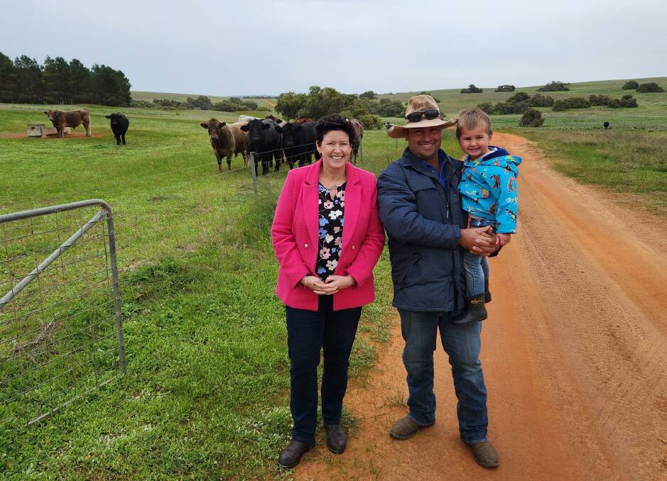 WA Agriculture and Food Minister Jackie Jarvis with Carbon Farming and Land Restoration Program grant recipient Murray Grey.
He is holding son, Jess, on his familys Yathroo property, south west of Moora.