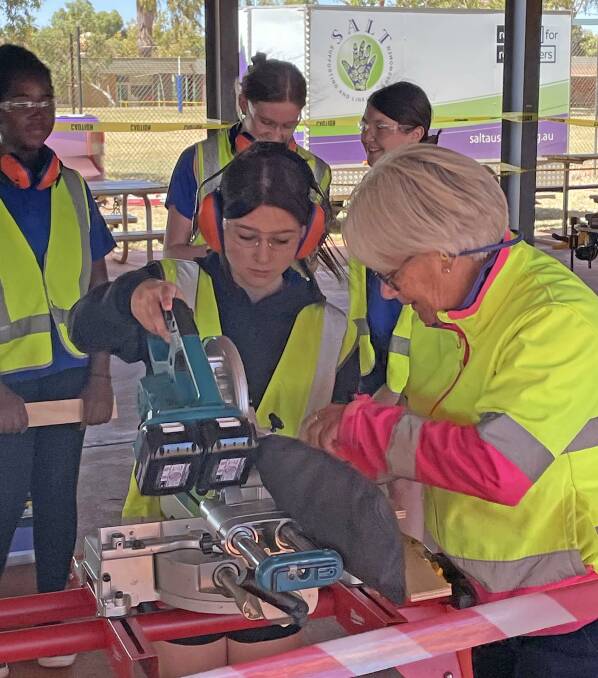 Permaculturalist Louse Mears helps a student during a mobile workshop at Newman last year. Ms Mears is part of the team which delivers trades-based lessons to students, via a nation-wide program called SALT, which is planning a big trip through the Wheatbelt later this year. Pictures: Supplied