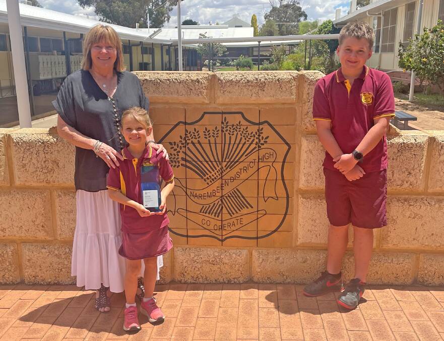 Narembeen Primary and District High School principal Chris Arnold with year 2 student Annie Robinson and Stephen Sherwood, who is in year 7 this year. Annie is holding the schools award for Excellence in Teaching and Learning in Primary. Picture: Supplied