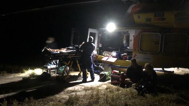 The RACQ Capricorn Rescue's onboard doctor and critical care paramedic working on the patient at the Byfields accident site. Photo - supplied.