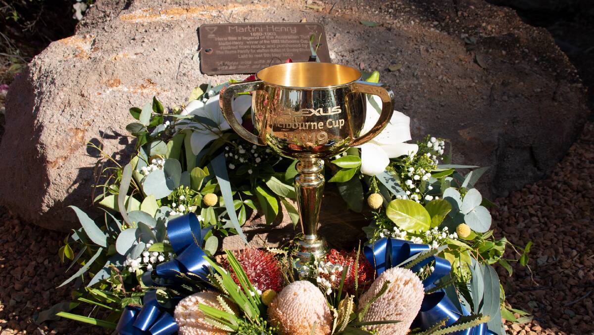 The 2019 Lexus Melbourne Cup placed beside the plaque commemorating the Longreach burial place of 1883 winner, Martini-Henry. Picture supplied by Longreach Regional Council.