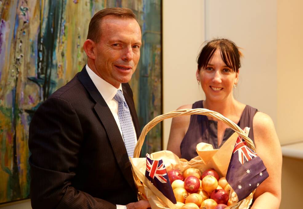 Former Onions Australia CEO, Lechelle Earl, presents former Prime Minister, Tony Abbott, with a basket of onions. File picture