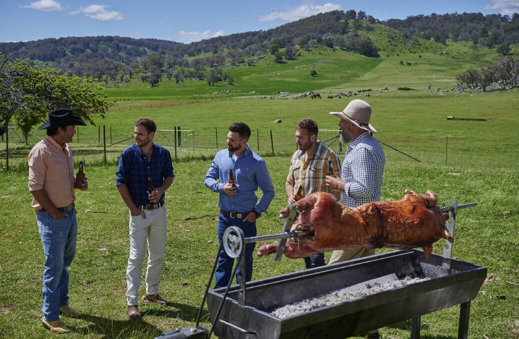 YARNING: The lads all get together around a spit roast to talk about pork and pashing. Photo: Seven
