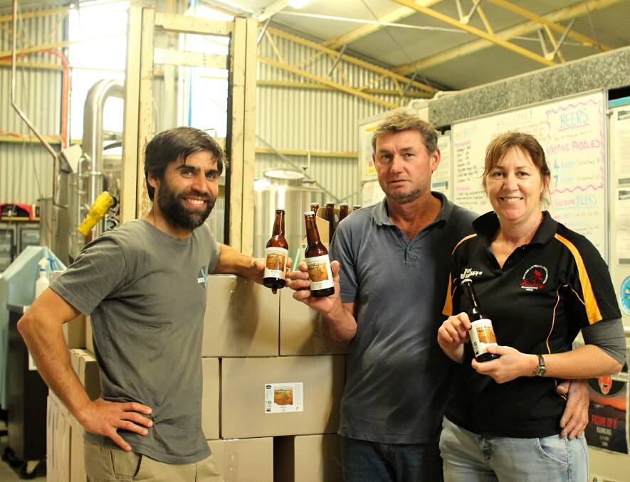 Off the Richter Ale: Lucky Bay Brewing owner Nigel Metz alongside Meckering residents Wayne and Sharon Reynolds with the Richter Ale brew. Photo: Jesinta Burton.