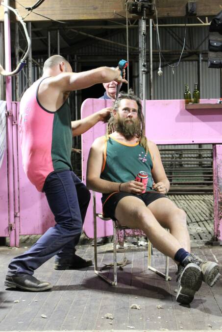 Jumbuk Shearing's Tom Reed cuts Brad Phillip's hair and beard at the 'Shearing for Liz' pink shearing day at the Davies family's Yorkrakine shearing shed. The day in April raised $32,000 for the National Breast Cancer Foundation.