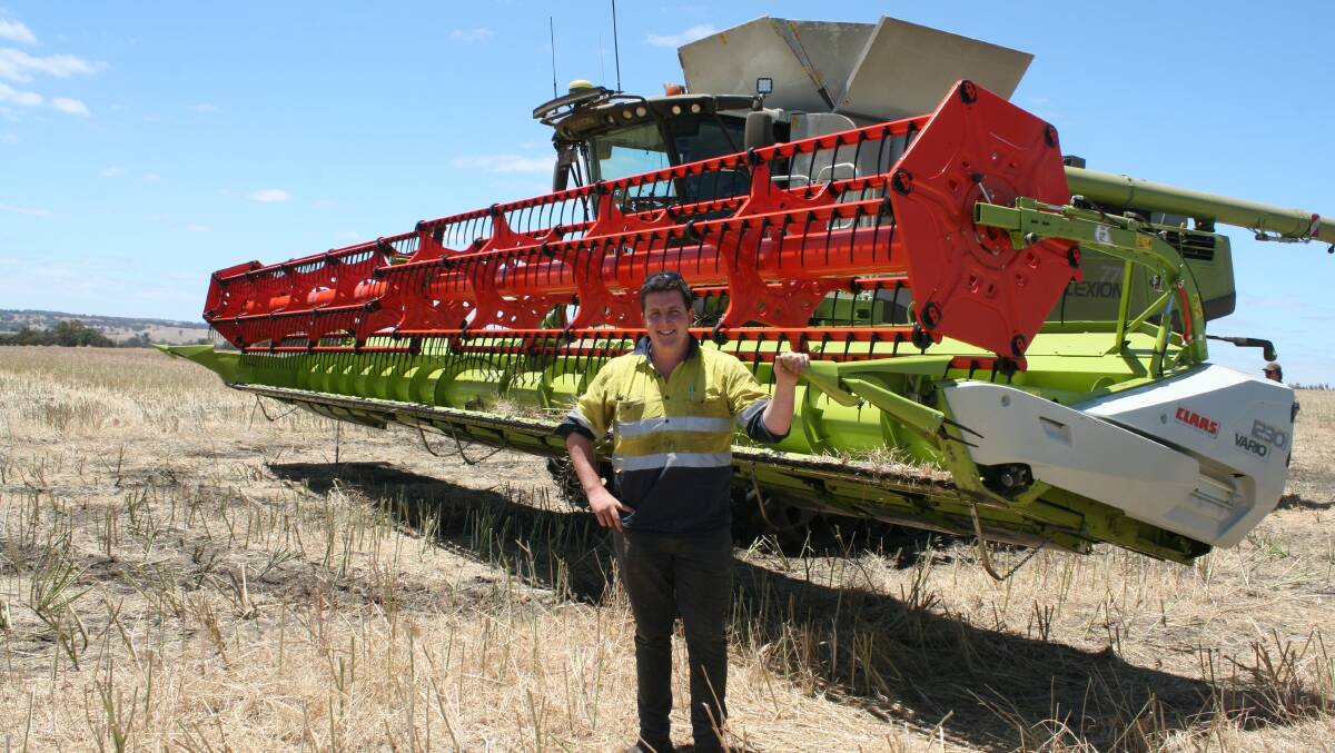 James Heggaton with one of his new CLAAS Lexion headers that will be kept busy until January.