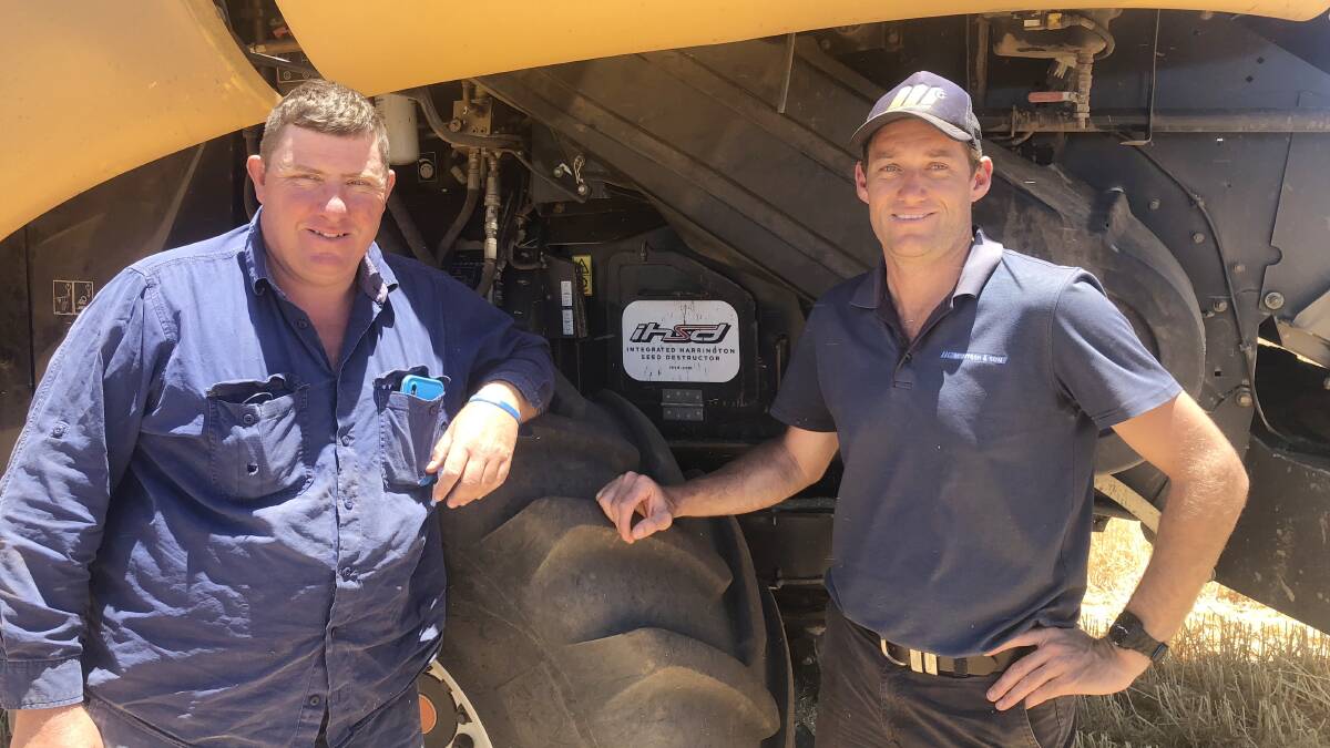 WA grower Warren Treasure (left), Moonyoonooka, pictured with Craig Harrington, McIntosh & Son, Geraldton and the upgraded Integrated Harrington Seed Destructor (iHSD) fitted to the family's new harvester, a New Holland CR 10.90.