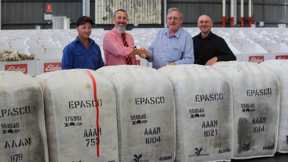 Elders WA wool manager Danny Burkett congratulates Rod Taylor (second right) on his last wool clip during 37 years as manager at Epasco Farms, Condingup. With them are farm workers Shaun Bennett (left) and Jay Daw.